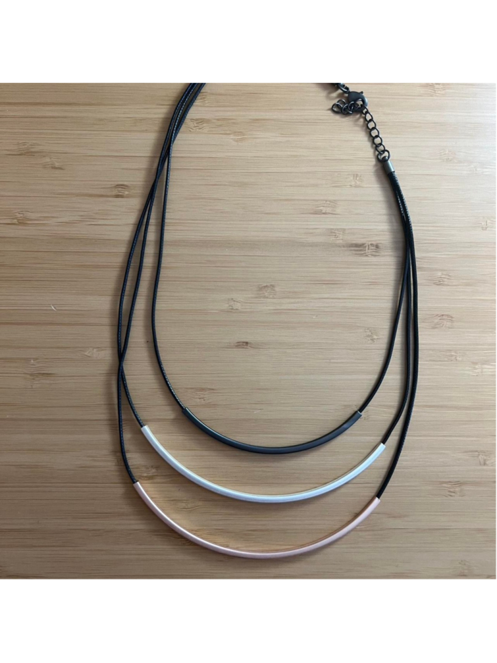 Boho necklace with black string and various types of metal
